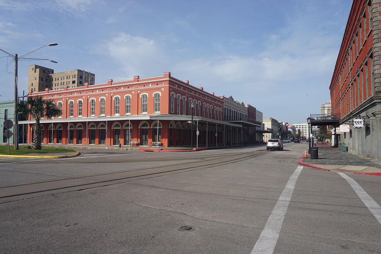 Historic red brick commercial buildings lining a street in Galveston's Strand Historic District