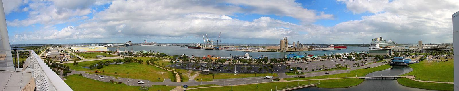 Panoramic view over Port Canaveral with green space, roads and port buildings in the distance