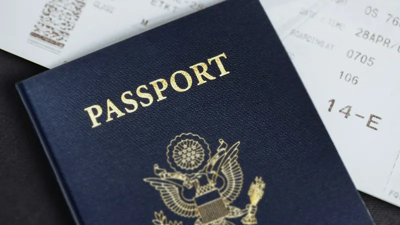 Passport resting on printed travel tickets