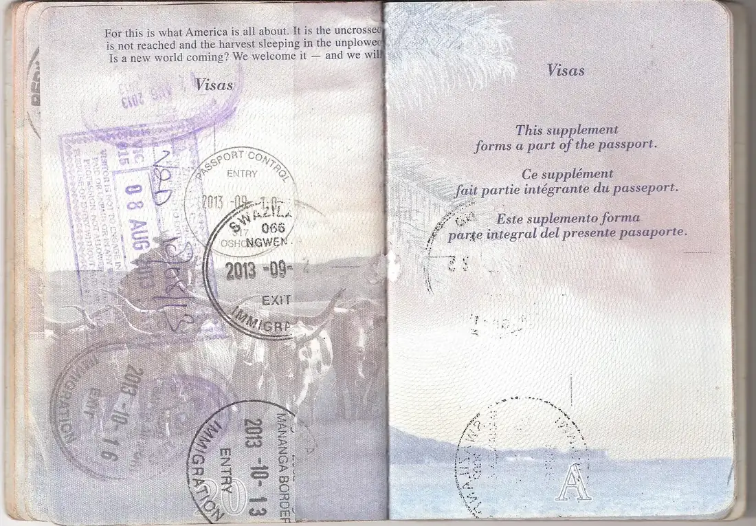 Open U.S. passport showing visa pages with entry stamps