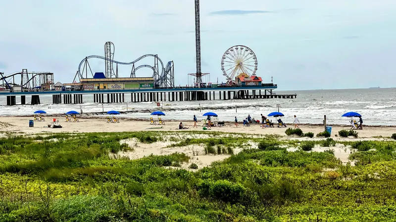 Galveston beach with an amusement pier in the distance