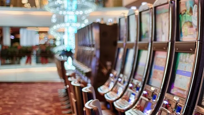 Row of slot machines in a bright casino