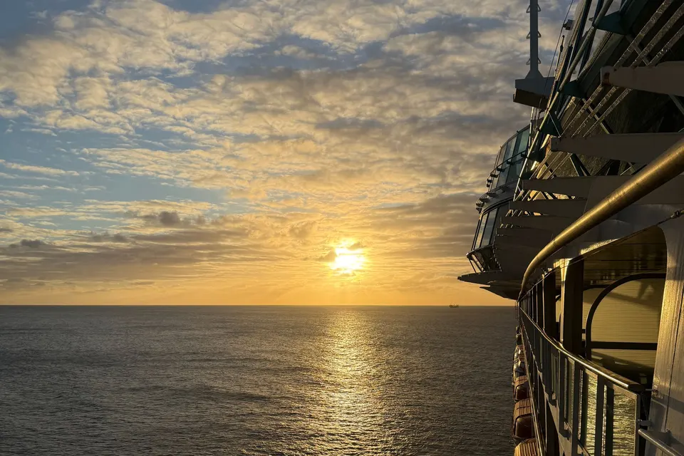 Sunset over the ocean from a cruise ship deck
