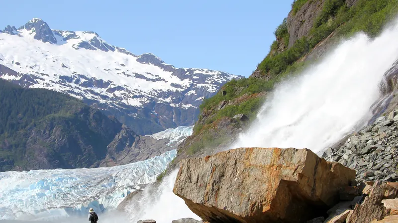 Nugget Falls pouring down the rocks beside Mendenhall Glacier