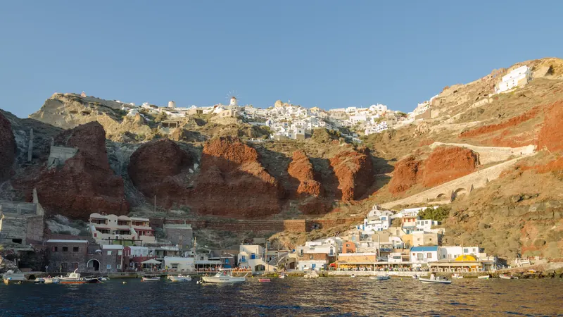 Ammoudi Bay's waterfront below the red cliffs of Oia, Santorini