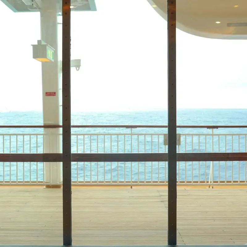 Ocean view through the open balcony door of a cruise ship cabin